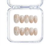 Handmade Singapore press on nails in short oval shape with greige tones and golden shimmer by Naillover