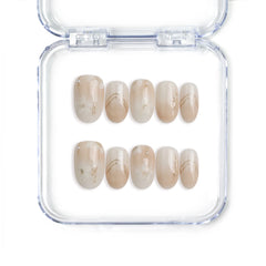 Handmade Singapore press on nails in short oval shape with greige tones and golden shimmer by Naillover