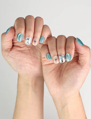 Mint Frost blue shimmer handmade press on nails with crystal accents and bow, Singapore design by naillover, worn on model’s hand