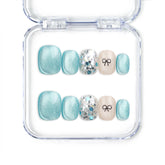 Mint Frost handmade blue shimmer press on nails with crystal accents and bow, Singapore design by naillover