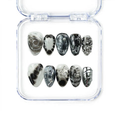 Naillover Moonlit Noir handmade press on nails featuring black and silver marble patterns, chrome swirls, studs, and star accents for a bold trendy look.