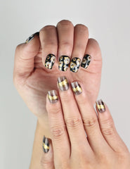 Close-up of Mystic Flow press on nails showing dark and light hues with gold and silver accents, trendy and artistic nails design