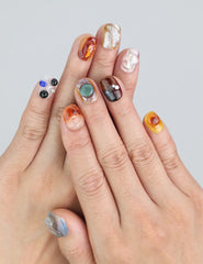 Wearing Naillover Amber Whisper press on nails in warm amber and olive—bold and earthy tones with a refined finish.