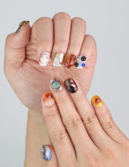 Close-up of Naillover handmade press on nails in Amber Whisper—rich tones with elegant curve and sheen.