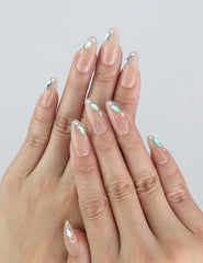 Model wearing Aqua Gem nails — Naillover Singapore press on nails with nude base and shimmering blue crystals.