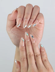 Close-up of Aqua Gem press on nails by Naillover — blue gem accents on a soft nude handmade base.