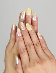 Model wearing Naillover Bloom Whimsy handmade press on nails Singapore with peach gradient and 3D flower accents.