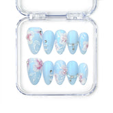 Naillover Blue Floral Diamond Singapore press on nails with matte blue base, white floral art, and pearl crystal accents