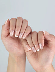 Naillover Blush Bowlet handmade press on nails styled on fingers—soft nude base with romantic detailing.