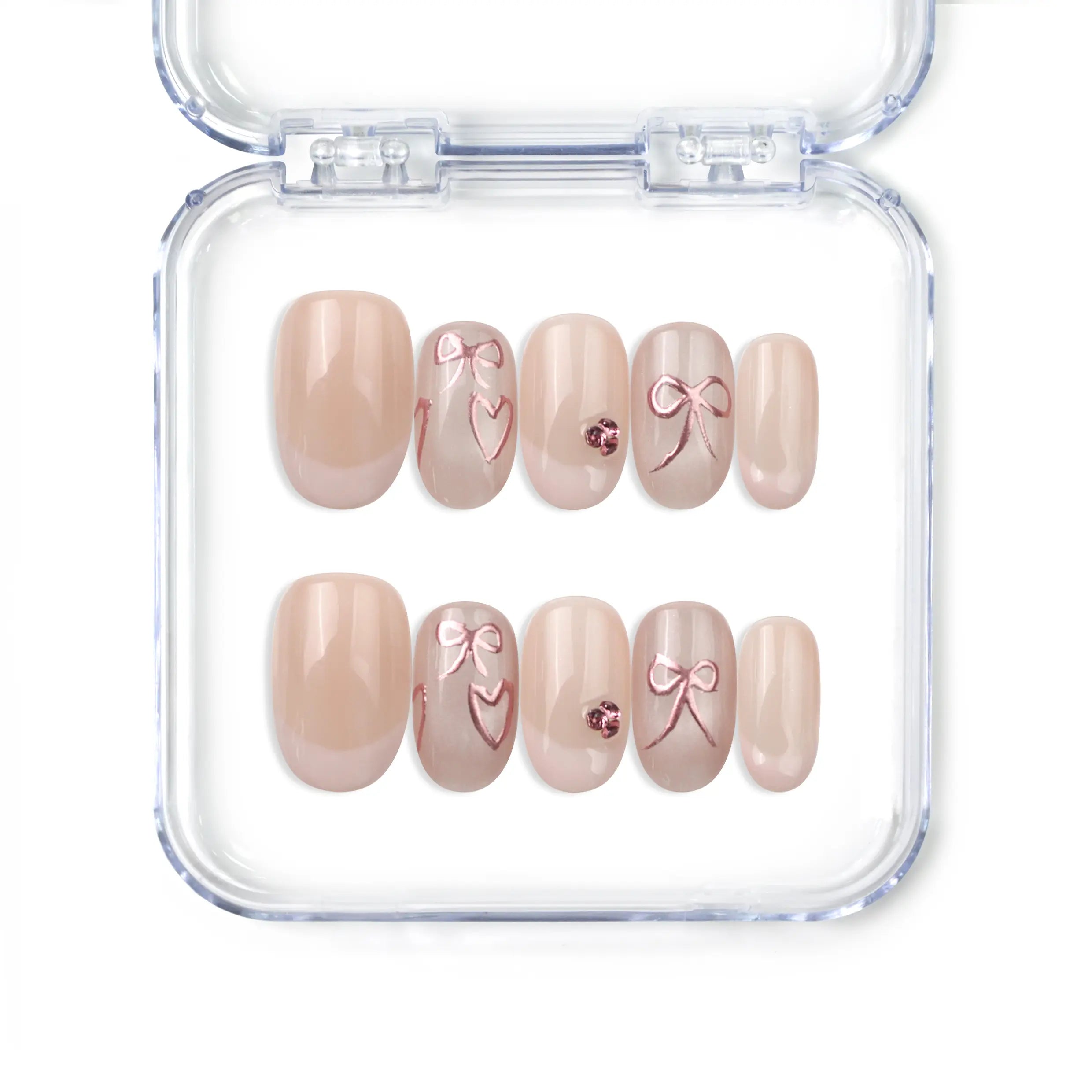 Naillover handmade press on nails in nude with French tips, champagne heart and bow accents, from Singapore press on nails collection.