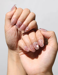 Elegant manicure featuring Blush Diamond Whisper handmade press on nails SG in soft blush with sparkle.