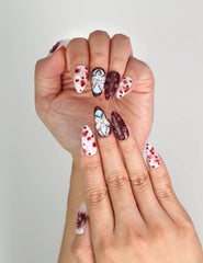 Close-up of Naillover Blush Enigma handmade press on nails Singapore with playful polka dots and floral details.