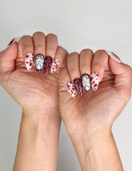 Naillover Blush Enigma trendy nails styled with outfit, highlighting chic burgundy and white nail art.