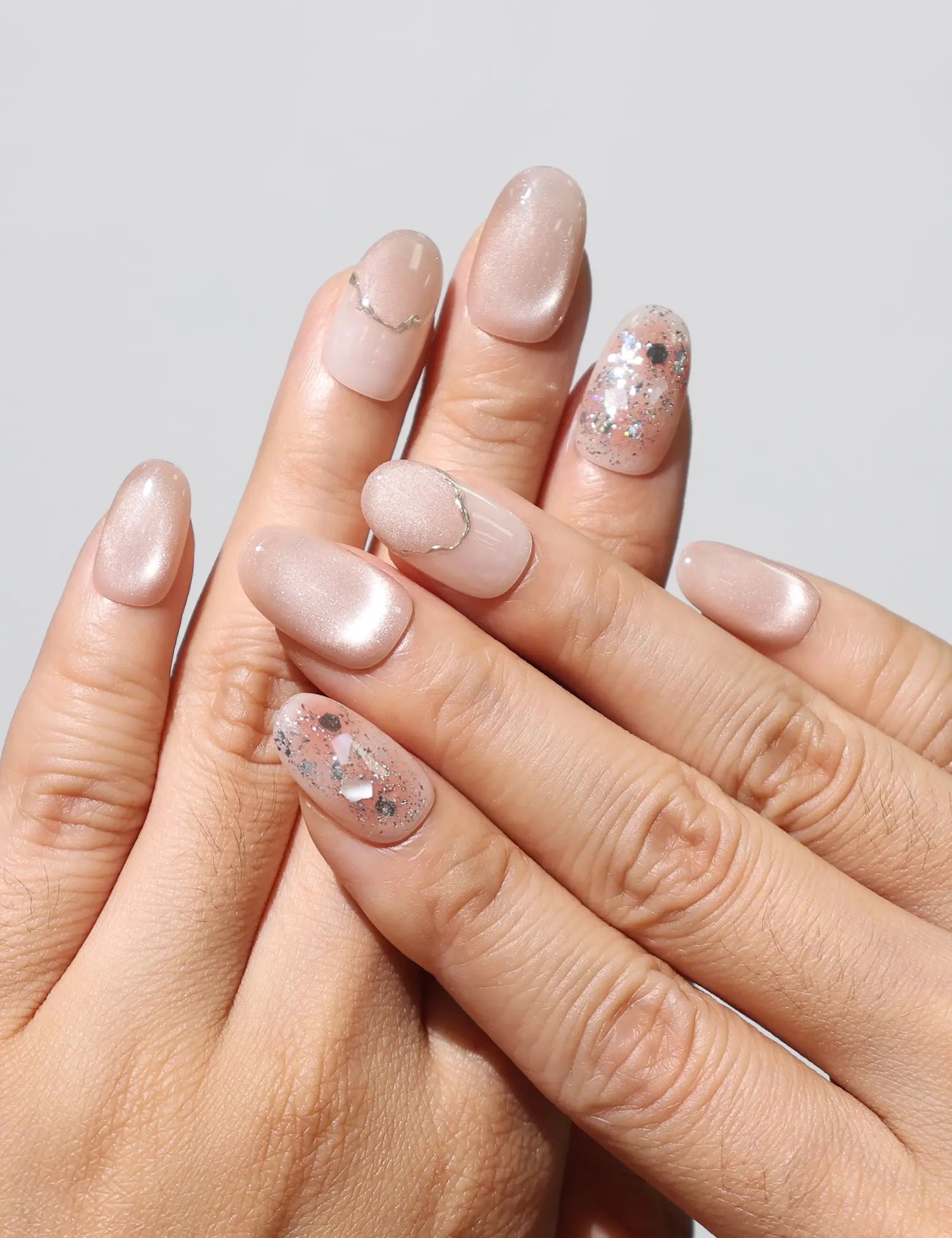 Wearing Blush Gemlet Gleam handmade Singapore press on nails in sheer pink gradient with silver accents by Naillover.