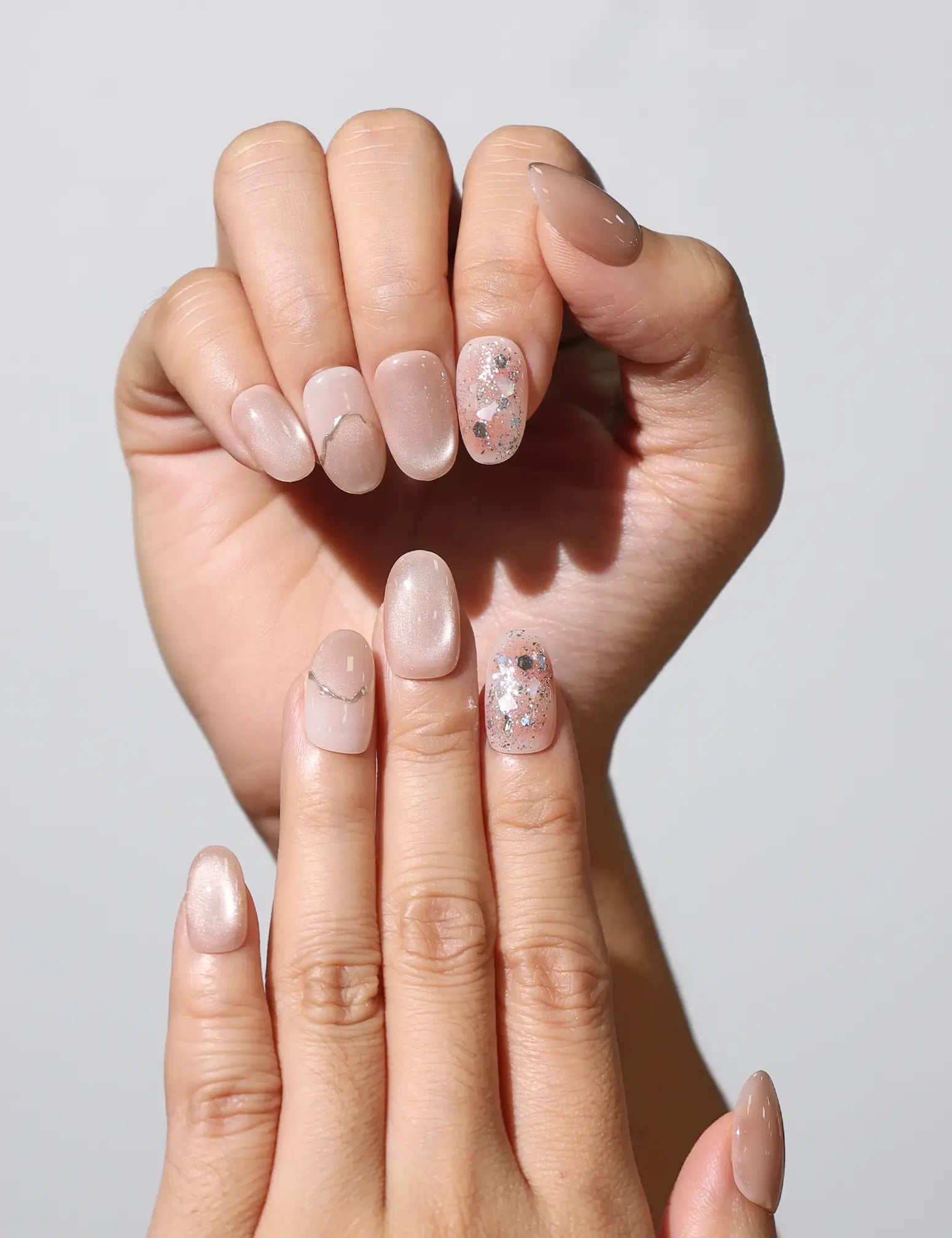 Close-up of Blush Gemlet Gleam pink gradient handmade press on nails SG with silver accents by Naillover.