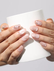 Holding a cup while wearing Blush Gemlet Gleam handmade pink gradient Singapore press on nails with silver accents by Naillover.