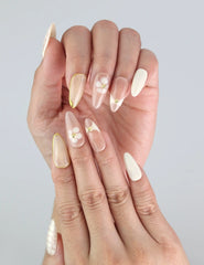 Close-up of Naillover Blush Lattice nails on hand — soft summer tones and sleek almond silhouette from press on nails SG collection.