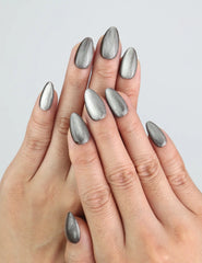 Hand wearing Chestnut Tone silver cat eye press on nails in short almond shape.