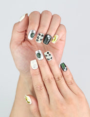 Close-up of Chic Contrast nails with creamy white and jet black contrast and 3D floral decor.