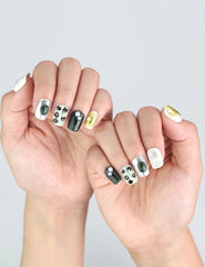 Naillover press on nails in Chic Contrast style, styled on hands with chrome beads and dark floral aesthetic.