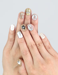 Model wearing Naillover Chic Doodle nails with soft neutrals and 3D bows in a stylish everyday setting.