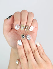 Close-up of Chic Doodle nails featuring coffee, ivory, and black tones with delicate chrome and minimal line accents.