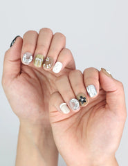 Hands with Naillover Chic Doodle press on nails, showcasing bow details and clean modern design.