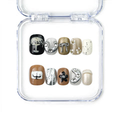 Naillover Chic Doodle handmade press on nails in coffee, ivory, and black with bows and line art, from Singapore press on nails collection.