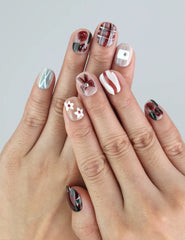 Model hand showing Naillover Chocolate Plaid press on nails with floral accents, bows, and soft cream plaid—handmade coquette nails in Singapore.