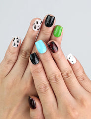 Wearing Cocoa Cow Mix short coffin handmade press on nails with brown cow print by Naillover Singapore.