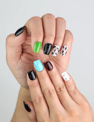 Close-up of Cocoa Cow Mix cow print and colorful accent short coffin press on nails, Naillover SG collection.