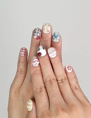 Model wearing Naillover Cozy Hugs handmade Singapore press on nails with colorful 3D accents and fun phrases.