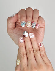 Close-up of Naillover Cozy Hugs Singapore press on nails showing playful nail art with words “Happy Lazy” and “Love Yourself.”