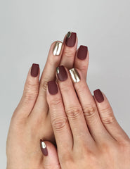 Naillover Crimson Glint press on nails in burgundy with metallic shimmer, elegant hand pose