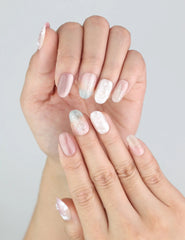 Naillover Dusk Butterfly nails on hands, featuring pink, beige, and mint details with pearlescent finish.