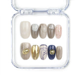 Naillover Eclipse Core handmade Singapore press on nails with neutral tones, gold accents, marbled designs, and shimmering glitter finish.