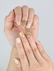 Close-up of Naillover handmade press on nails in Gilded Grace—3D flower detailing and gold accents.