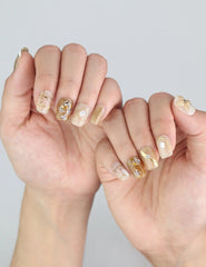Model showing Naillover Gilded Grace Singapore press on nails in neutral beige with elegant floral textures.