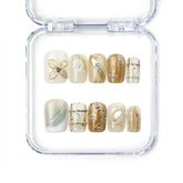 Naillover Gilded Grace handmade press on nails in soft beige with sculpted 3D floral accents and gold shimmer, from the Singapore press on nails collection.