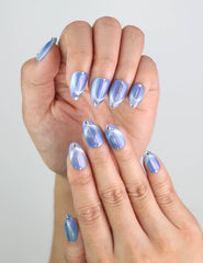 Close-up of fingers featuring icy blue cat eye press on nails handmade by Naillover.
