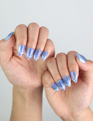 Hand shot showing blue cat eye shimmer of Glacier Veil press on nails from Naillover Singapore.