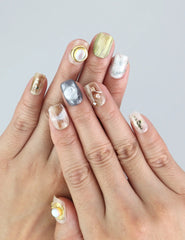 Wearing Naillover Gold Leaf Whisper press on nails—gold foil, 3D pearl, and floral details on a soft blush base.