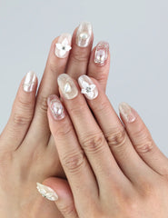 Model hand wearing Naillover Lace Flower press on nails—3D floral accents and pastel pink tones for a cute and classic style.