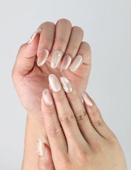 Close-up of Lunar Petal handmade nails on hand, highlighting sparkles and feminine pink tones.