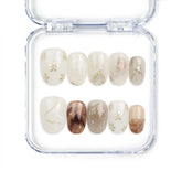 Naillover Marble Blossom handmade Singapore press on nails with white and brown marble design and gold accents.