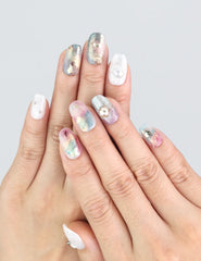 Model wearing Naillover Mermaid Sparkle nails, showcasing jelly-like shine in smoky green and purple.