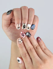 Close-up of Naillover handmade press on nails in Midnight Whisper—midnight polish and sculpted glitter petals.