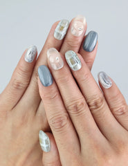 Wearing Naillover Misty Grid press on nails in short length with subtle grey-white grid patterns.