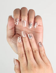 Close-up of Naillover Mocha Dot handmade press on nails, taupe with polka dots and cute bow accents