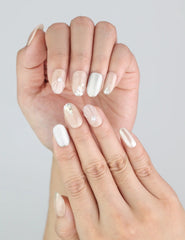 Naillover Nude Gleam nails on hand showing subtle glitter and clean oval shape.